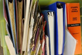 A collection of stamp albums and stamp sets from the 20th century.