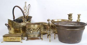 A large mixed lot of antique brassware to include candlesticks, cream pail, chestnut roasters,