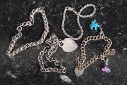 A silver 925 ladies bracelet having a silver padlock in the form of a heart together with another