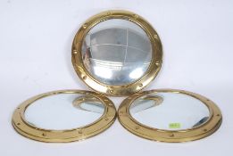 Three matching mid 20th century circular convex brass porthole style mirrors