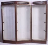A 20th century retro angular large shop display cabinet with sectional angled body having upper lit