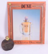 A vintage retro 20th century Christian Dior perfume shop advertising sign set on resin back plate