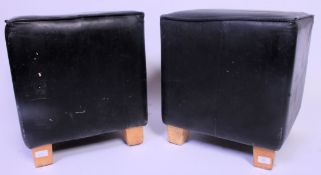 A pair of contemporary black leather square cafe - bar stools seats,