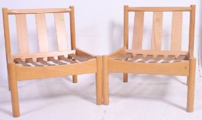 A pair of Ercol 741 staff / Industrial office chairs of beech construction ready for being