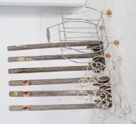 A pair of vintage wooden cricket training stumps together with a retro 1970's chrome magazine rack