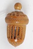 A 19th century vegetable ivory thimble case of acorn form having Stanhope globe finial showing '