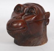 A Victorian style tea caddy / tobacco jar carved hardwood container in the form of a monkeys head.