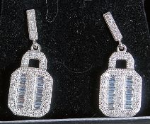 A pair of silver and cz set baguette cut