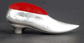 A vintage silver pin cushion in the form