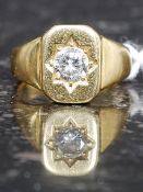 An 18ct gold and diamond ring. The centr