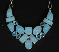 A 925 silver necklace set with a stylised lattis of blue gem stones. Total weight 98.