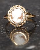 A 9ct gold hallmarked ring set with a shell cameo. Weight 1.5g. Size  N.