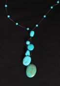 A stunning early 20th century large turquoise graduating pebble stone silver necklace.