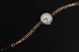A 9ct / 375 marked gold early 20th century ladies wristwatch having enamel face with good movement.