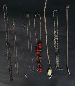 A collection of silver necklaces to include pendants, coloured stones, crucifix,