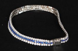 A contemporary  silver cz stone and sapphire set tennis bracelet, each stone being claw mounted.