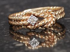 A 14ct gold and diamond rope twist ring with inset 1pnt diamond. Total weight 3.3g.