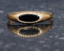 A 9ct gold hallmarked ring set with central black gem stone. Weight 1.4g.