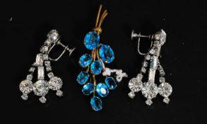 A pair of diamonte ladies drop earrings of graduating form together with a blue glass stone leaf