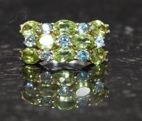 A ladies silver 925 stamped cocktail ring having pave set green and blue  gemstones being claw