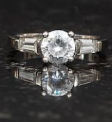 A ladies silver 925 dress / cocktail ring having central round cut CZ stone being claw mounted with