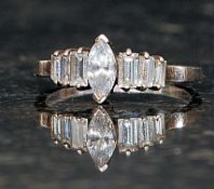 A silver ladies dress ring with central marquise cut CZ stone flanked by graduated baguette cut CZ