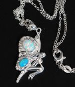 A silver and opal necklace pendant in the form of a fairy together with chain. Total weight 7g.