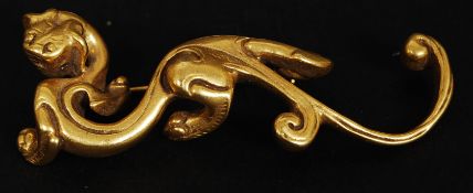 A vintage yellow metal simulated gold brooch in the shape of a chinese dragon. Marked MMA.