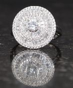 A ladies contemporary roundel head silver and cz stone inset dress ring. Total weight 4.8g.