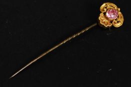 A 15ct gold mounted stick pin - hat pin with inset pink sapphire ? style stone. Total weight 2.