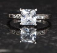 A silver 925 single CZ stone being cushion cut on claw mount with round cz  cut stones to shoulders.