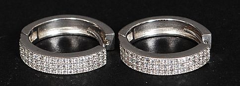 A pair of silver and cz stone channel set  hoop earrings. Total weight 4.
