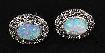 A pair of silver and opal earrings, the central opal stones being cabochon cut. 2.