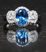 A ladies 925 silver cz stone and blue topaz 3 stone dress / cocktail ring. Total weight 4.2g Size R.