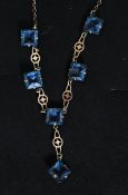 An Edwardian silver cornflower blue glass stone necklace.