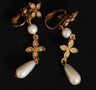 A pair of vintage ladies cz and simulated drop pearl earrings on yellow metal scrolled bodies.