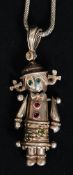 A silver articulated rag doll pendant necklace. The rag doll set on fine chain. 10.