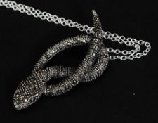 A silver and marcasite snake pendant set on a silver chain. Total weight 7.2g.