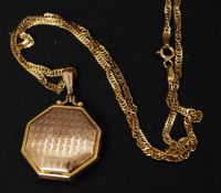 A 9ct gold necklace mounted with a 9ct gold front and back engine turned locket having a plain