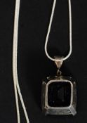 A large silver and smokey quartz pendant being claw mounted, contemporary silver chain.