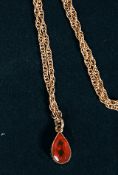 A 9ct gold hallmarked rope twist necklace with orange gemstone drop pendant. Total weight 2.7g.