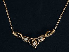 A 9ct gold and diamond hallmarked necklace with 3 1pt diamonds set in an art nouveau integral