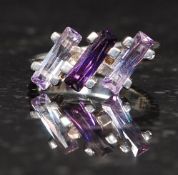 A ladies silver 925 dress ring inset with two tone baguette cut amethyst stones. Size O.5.