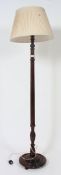 A 1950's mahogany standard lamp with reeded column and terraced base complete with the shade.
