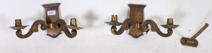 An excellent pair of brass twin sconce wall lights. Of rococo form rectangular plinth base.