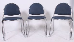 A stack of 3 1970's retro tubular chrome stacking dining chairs with original blue padded vinyl