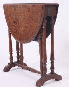 A Victorian oak sutherland occasional table raised on turned legs with swivel action having rise