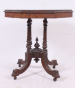 A Victorian walnut marquetry inlaid central table raised on 4 column supports having octagonal