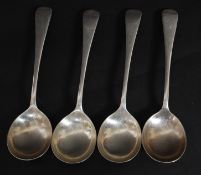 A set of 4 silver hallmarked serving spoons with deep round bowls and fiddle back stems.