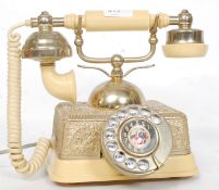 A retro 1970's Singapore ring dial telephone with decorative metal worked body
